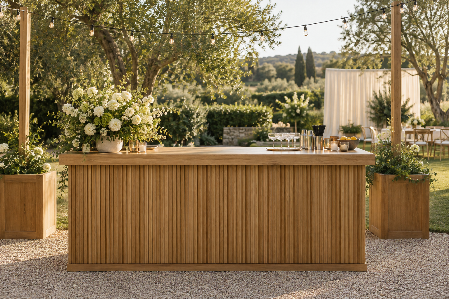 Modern rustic garden celebration with a wooden mobile bar, flowers and warm string lights